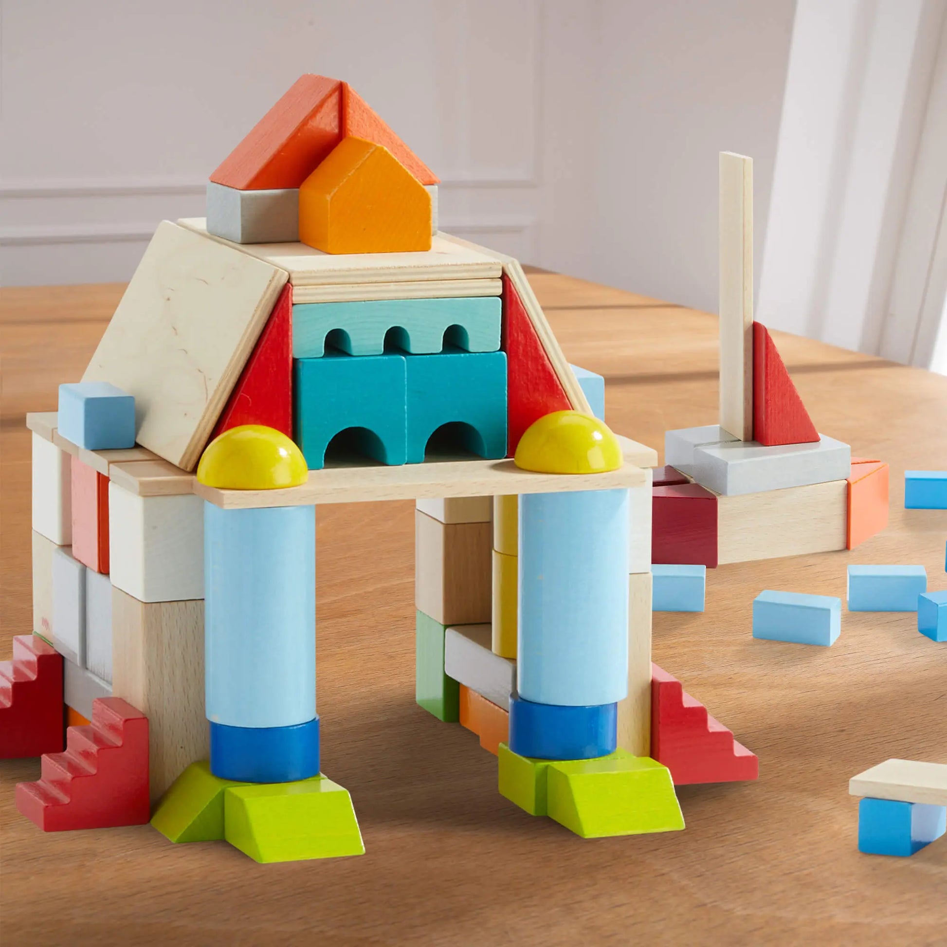 Colorful wooden building blocks on a wooden surface