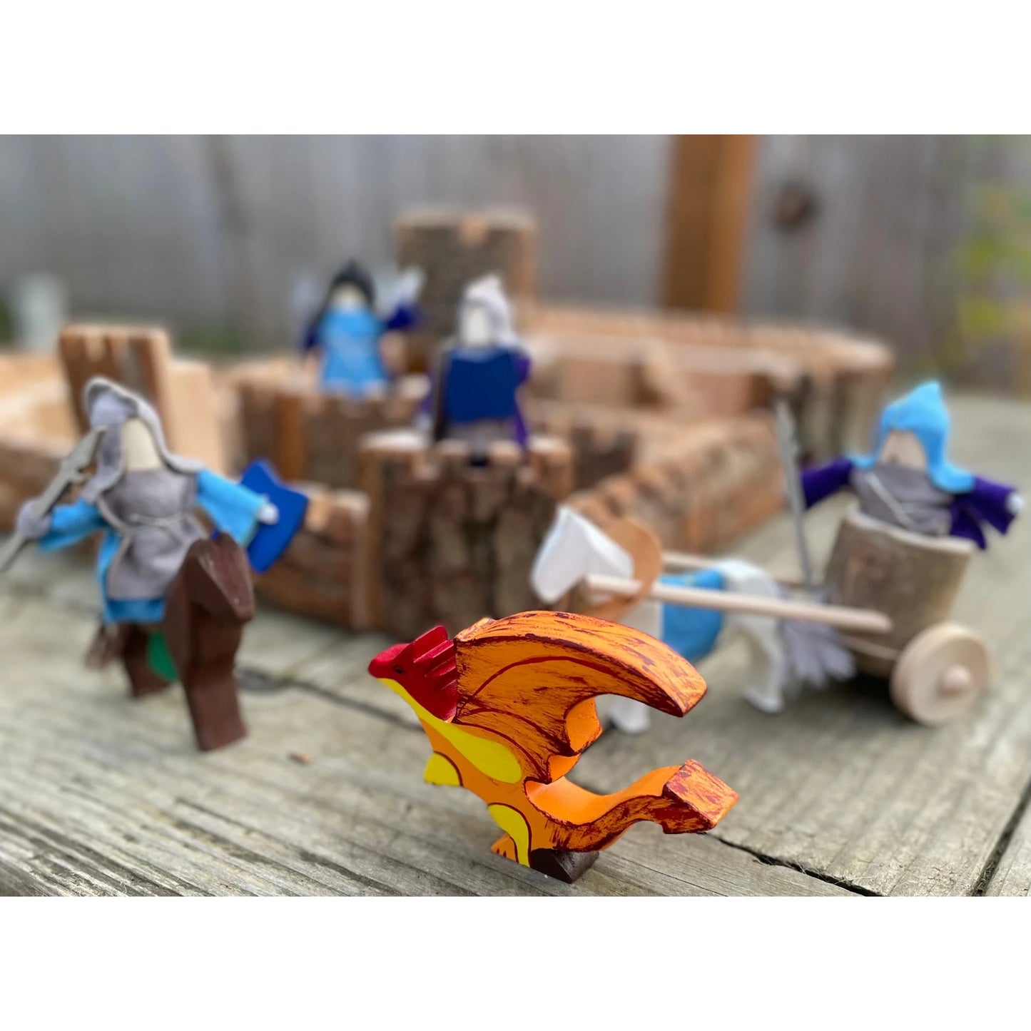 Natural wooden castle with knights and dragon during imaginative medieval play
