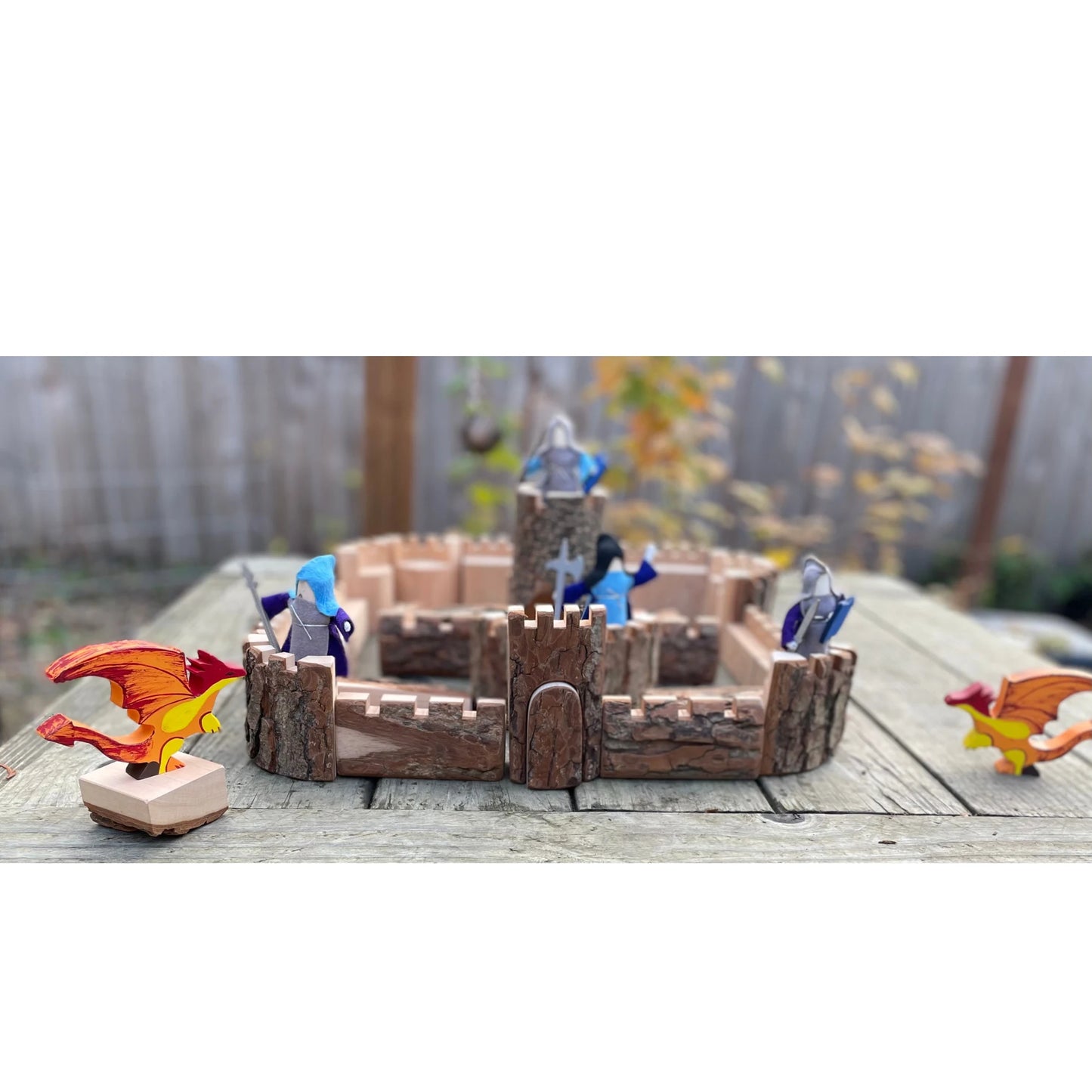 Natural wooden castle building set displayed outdoors for imaginative play