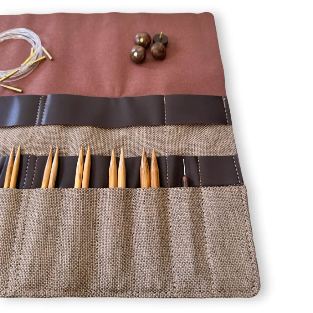 Knitting needle set in a brown case with a white background