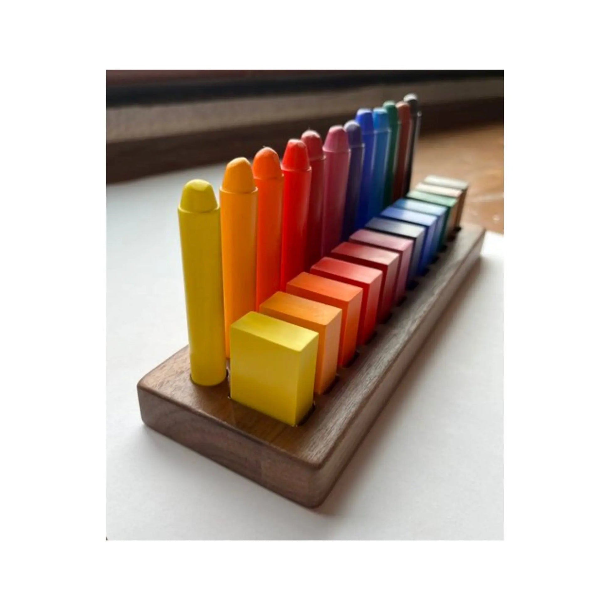 Colorful crayons on a wooden stand with a blurred background
