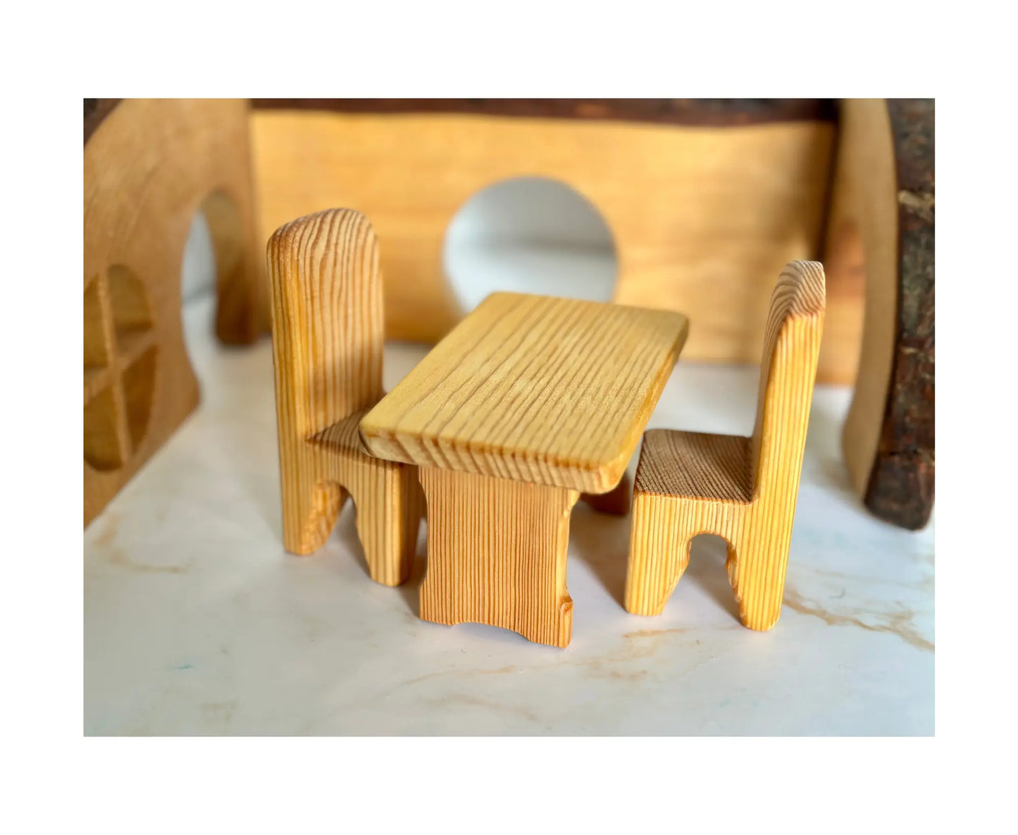 Angled view of wooden dollhouse table and chairs set with smooth natural finish