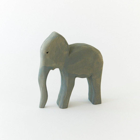 Small gray elephant figurine on a white background