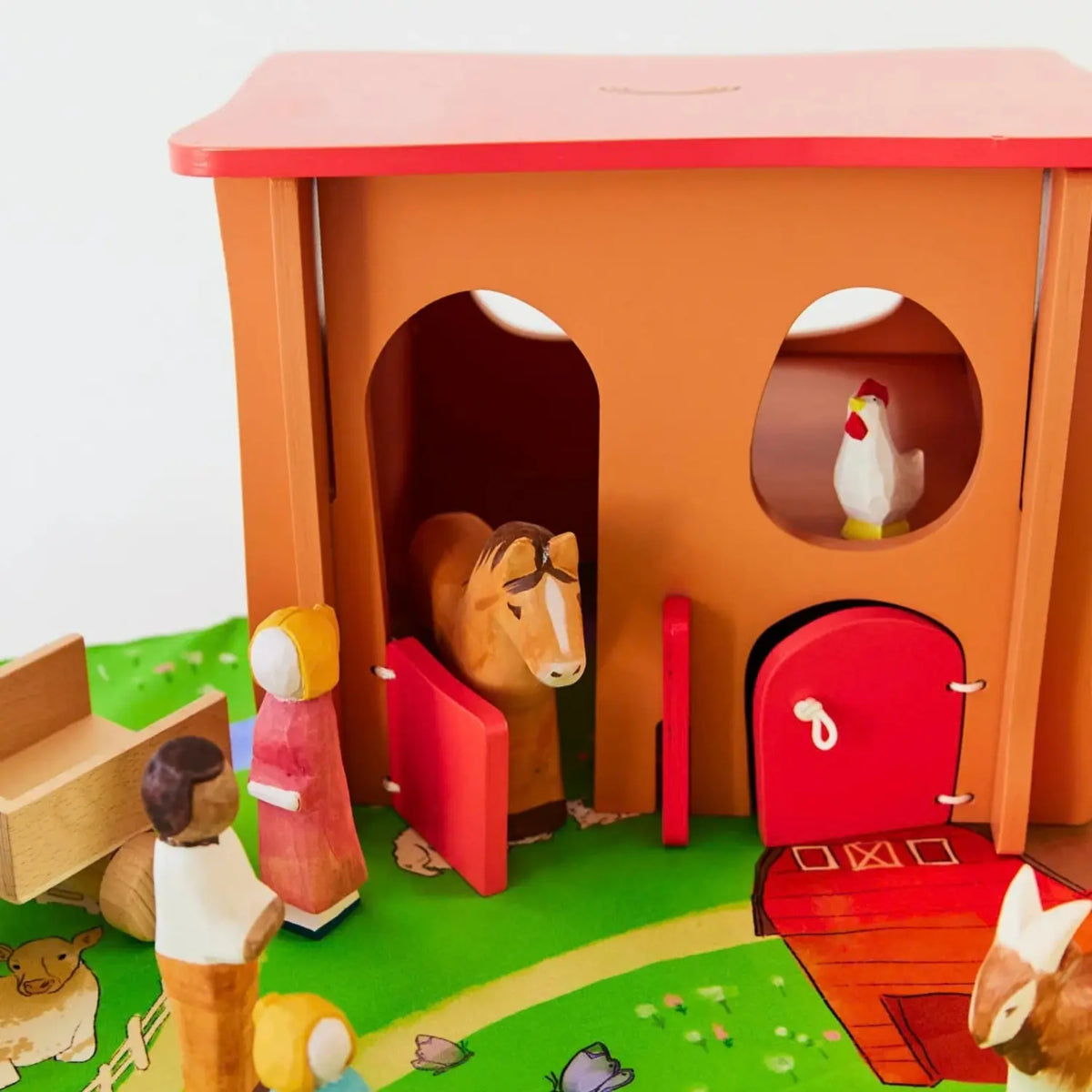 Sarah’s Silks wooden horse toy in a farm small-world scene with wooden figures and barn