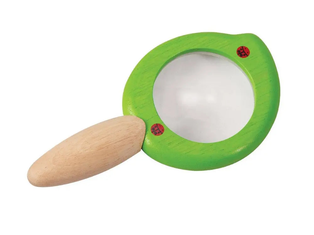 Toy magnifying glass with a wooden handle on a white background