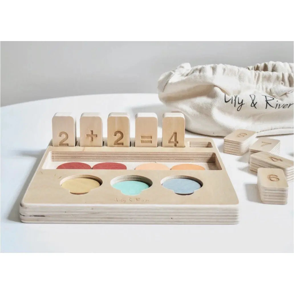 Wooden educational toy with number blocks and color sorting tray on a white surface.