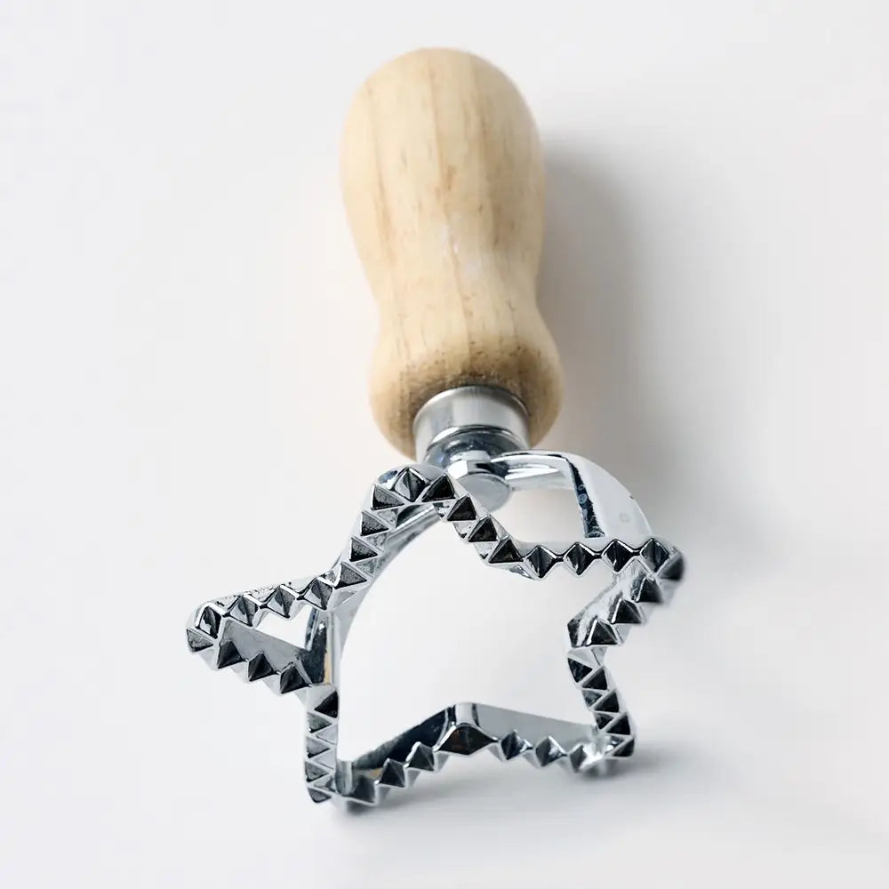 Close-up of wooden and metal star dough cutter for play dough and pretend baking