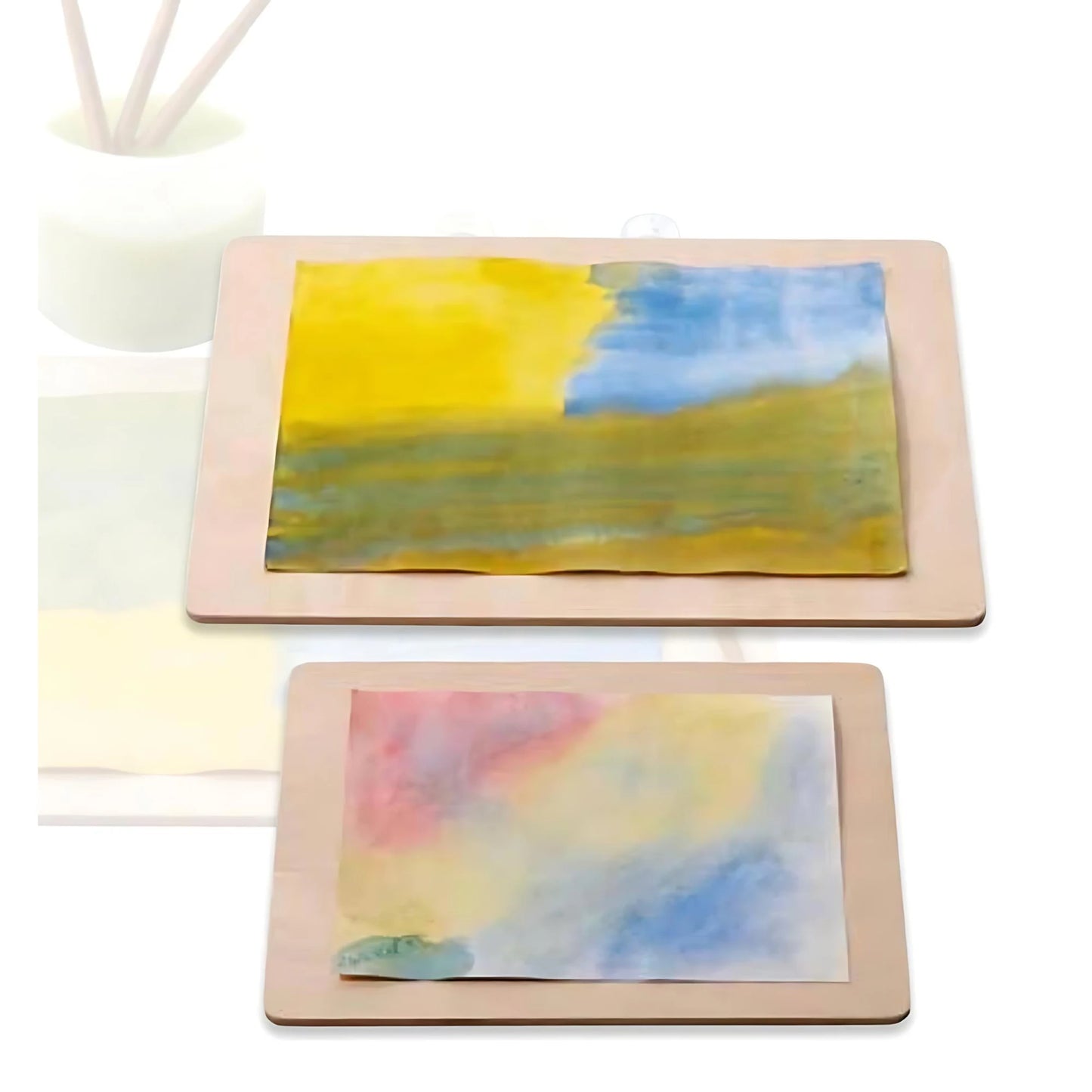 Two wooden painting boards with watercolor paintings on the boards