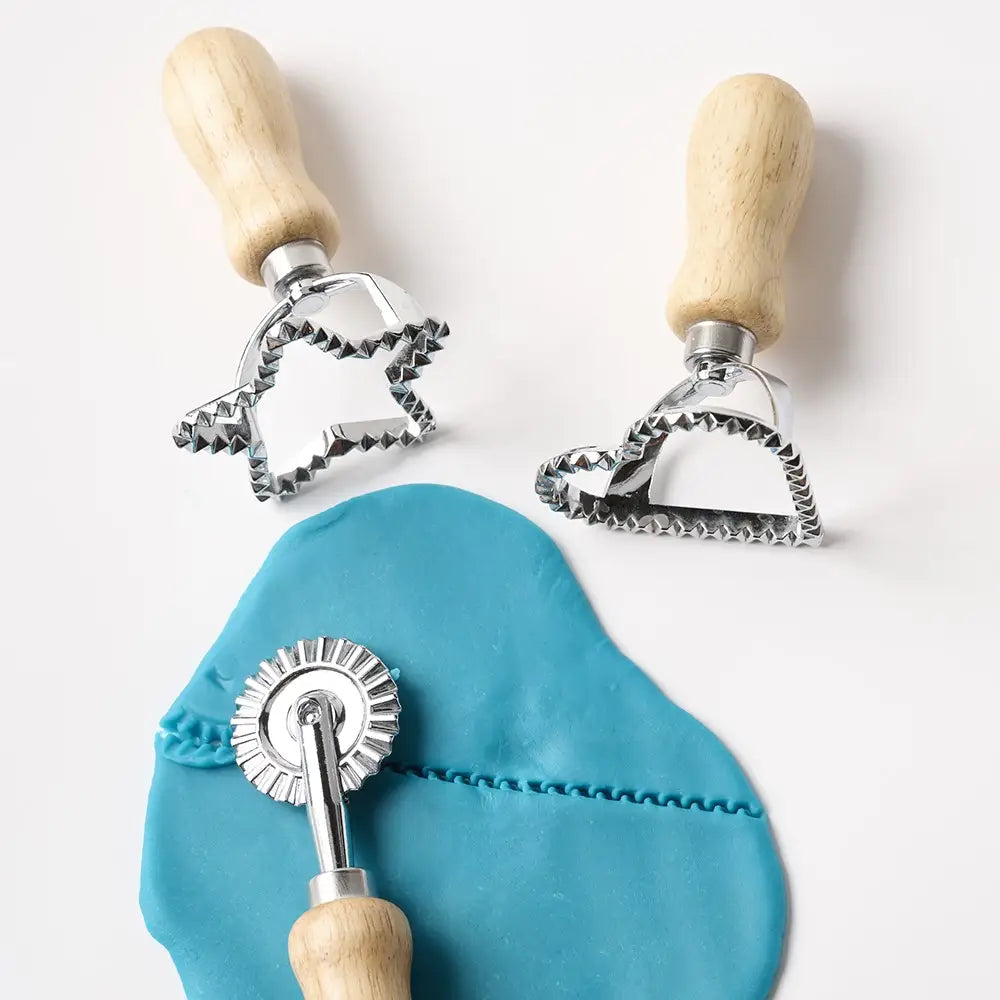 Wooden play dough tools cutting and shaping blue play dough on a sensory play table