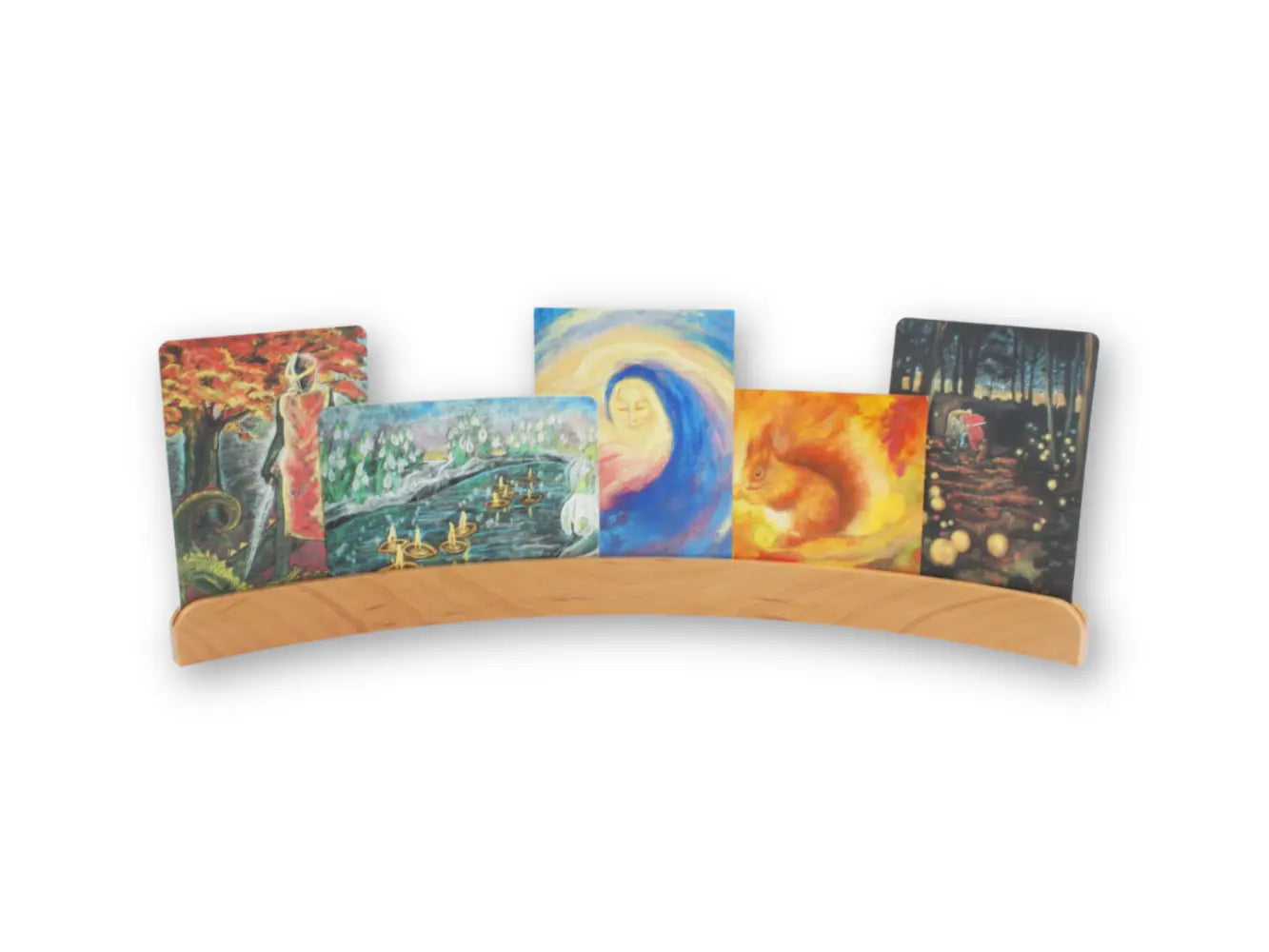 Wooden postcard holder displaying seasonal Waldorf-style art cards and postcards in a curved European beechwood stand.