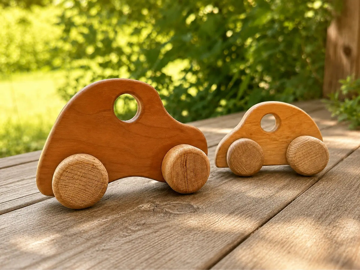 Wooden push cars on a rustic outdoor porch for natural open-ended play.