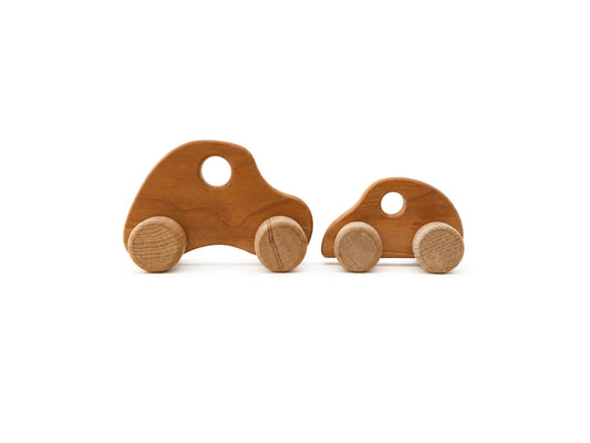 Wooden push cars in two sizes with cherry hardwood bodies and birch wheels.