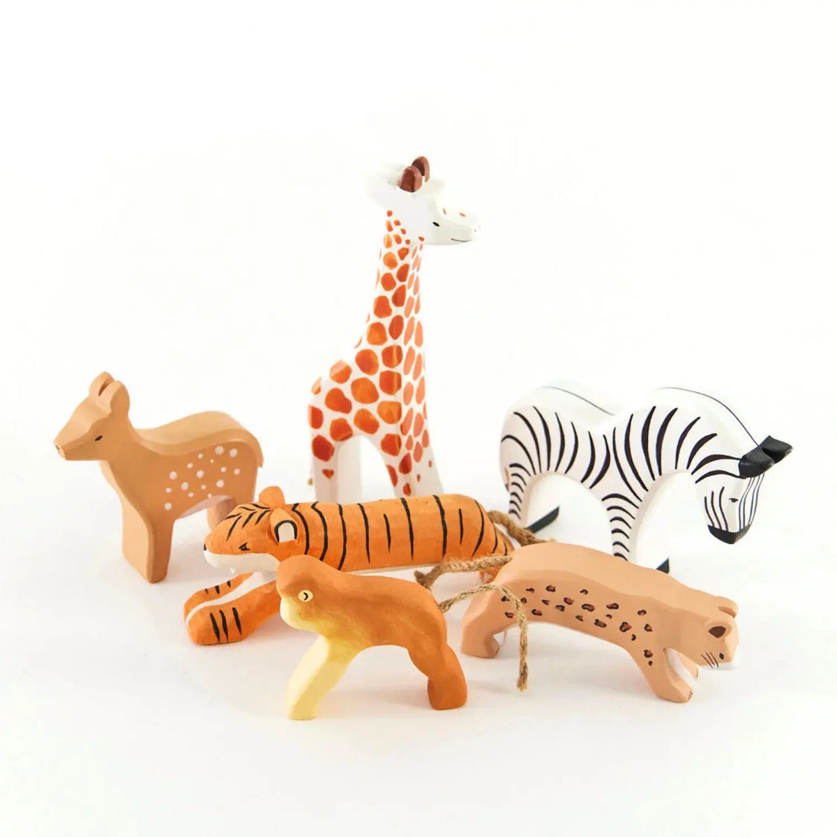 Wooden giraffe toy grouped with a wooden fawn, zebra, tiger, cheetah, and monkey for small-world play