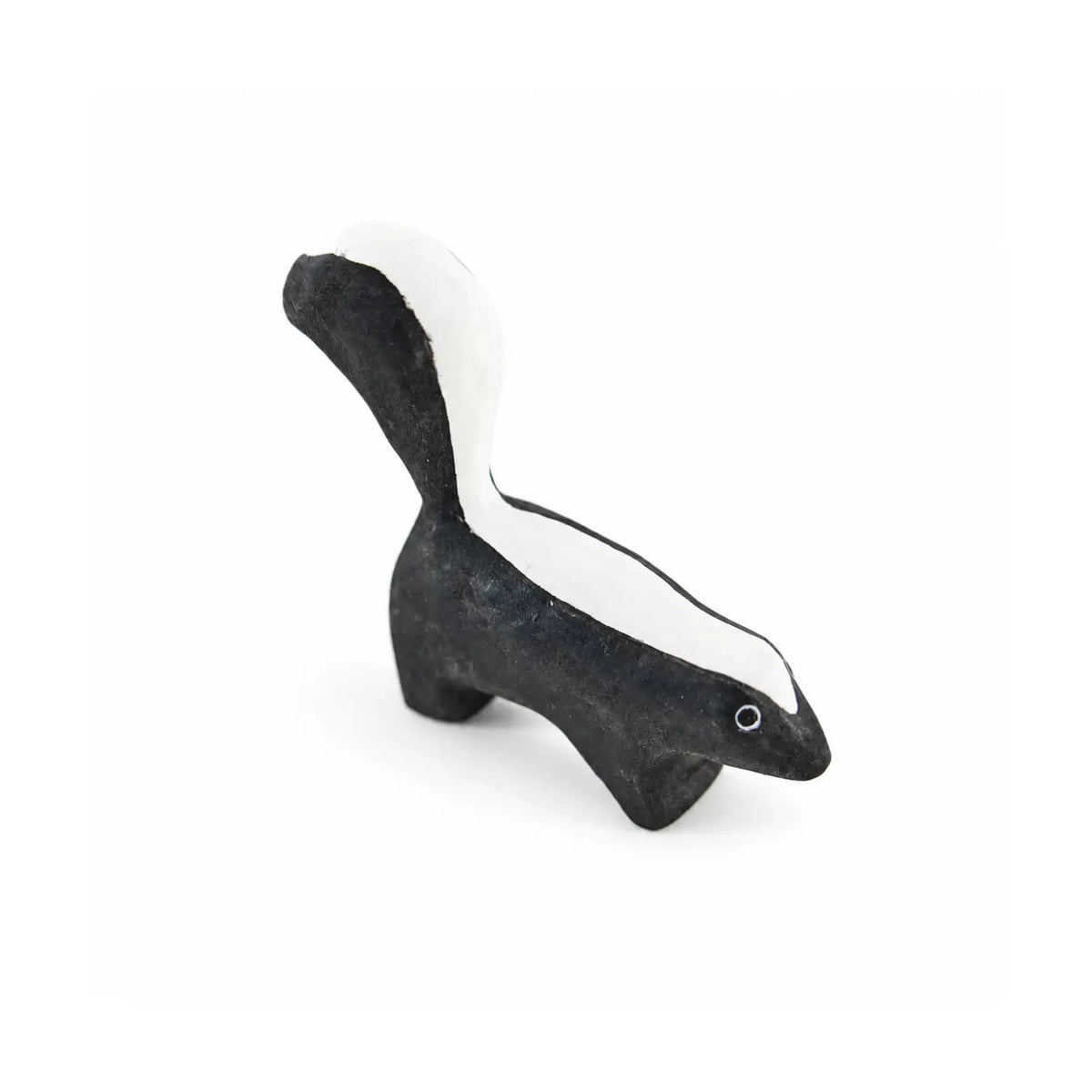 Angled view of Sarah’s Silks wooden skunk toy showing its black-and-white markings and curved tail