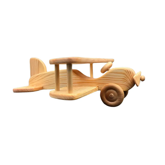 Side view of handcrafted wooden toy airplane with smooth beechwood grain and biplane design