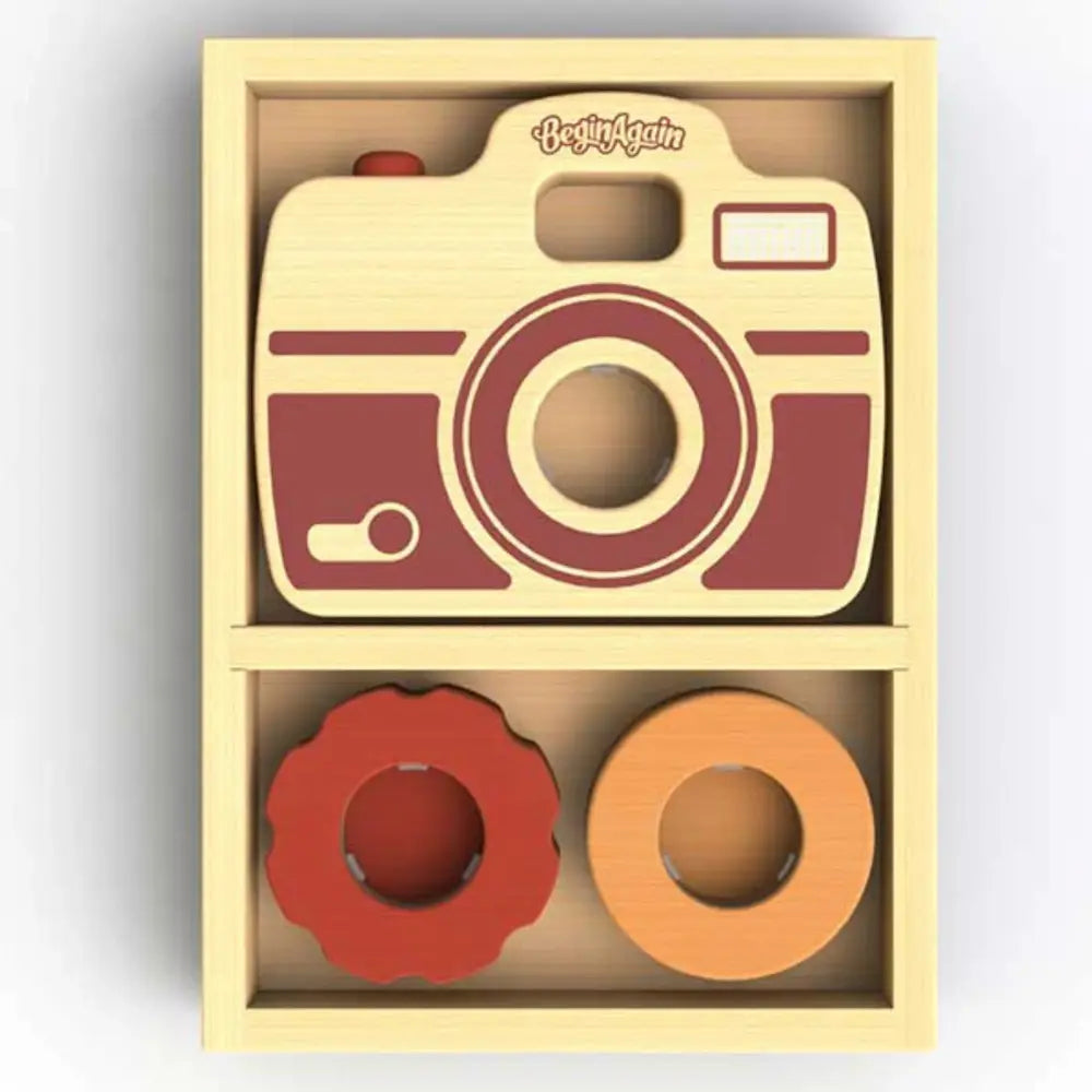 Wooden toy camera set with two circular shapes in a box