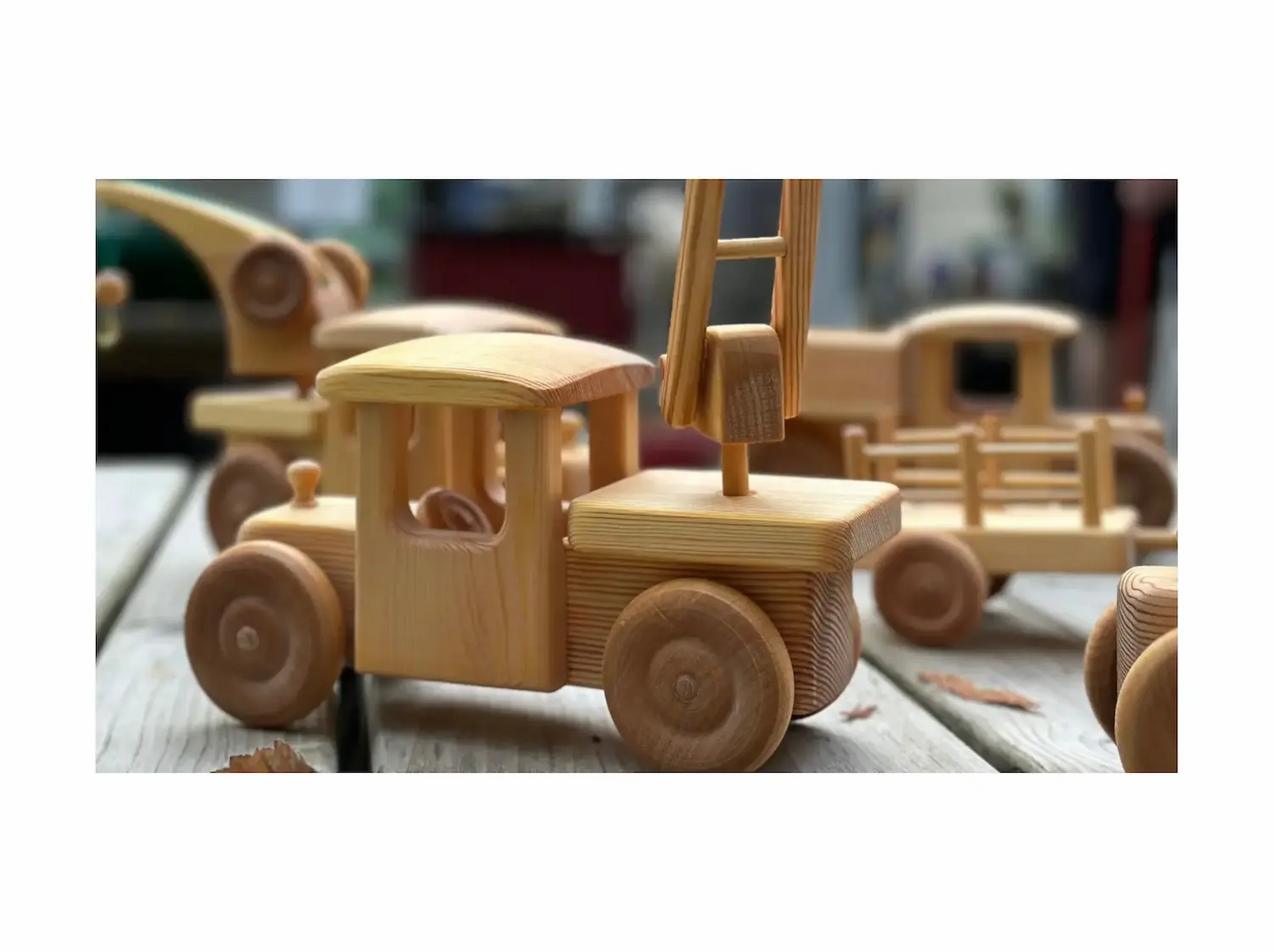 Handcrafted wooden toy firetruck with swiveling ladder made from beechwood and pine