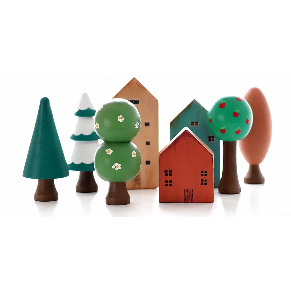 wooden trees next to play houses for small world play