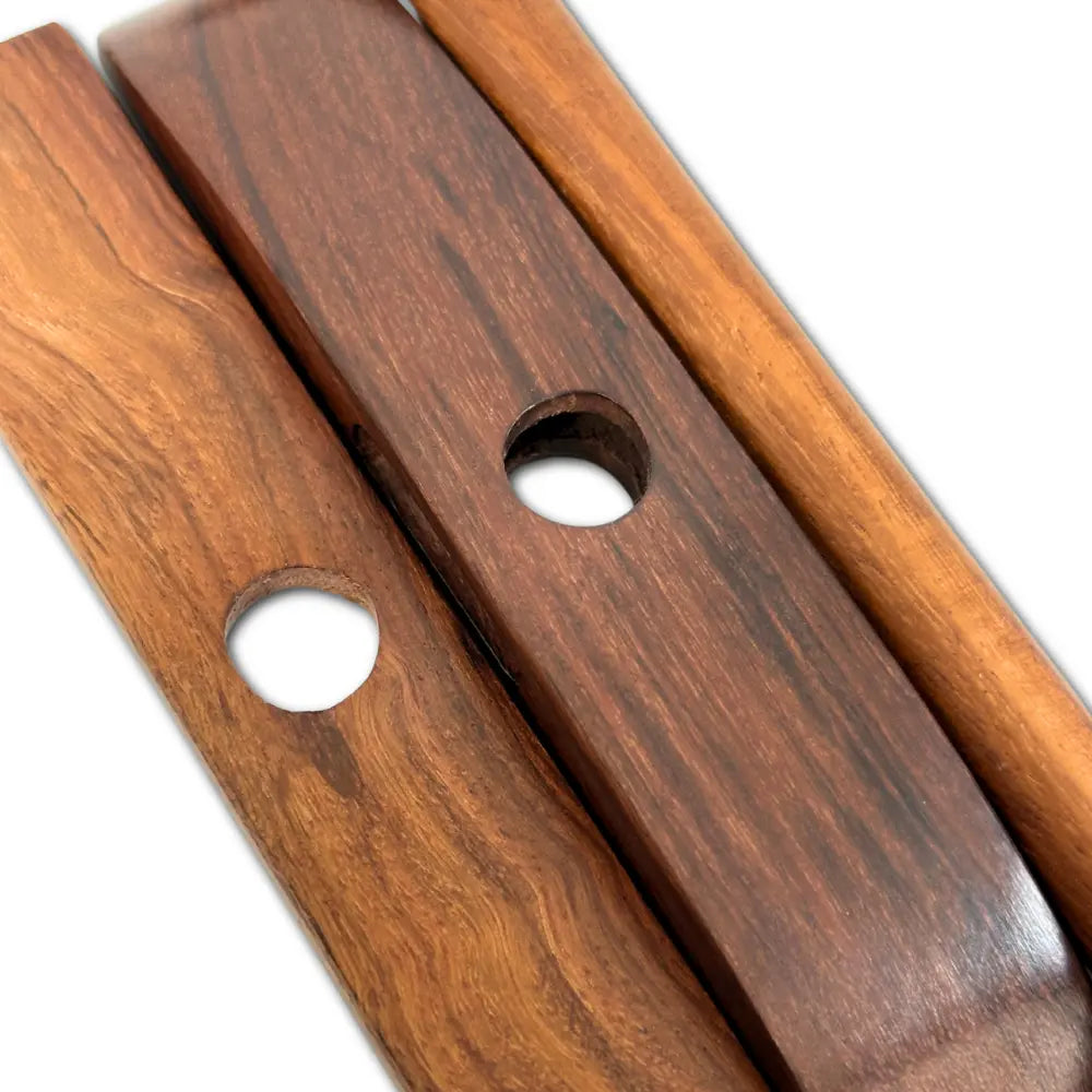 Close-up of two wooden flutes with a white background