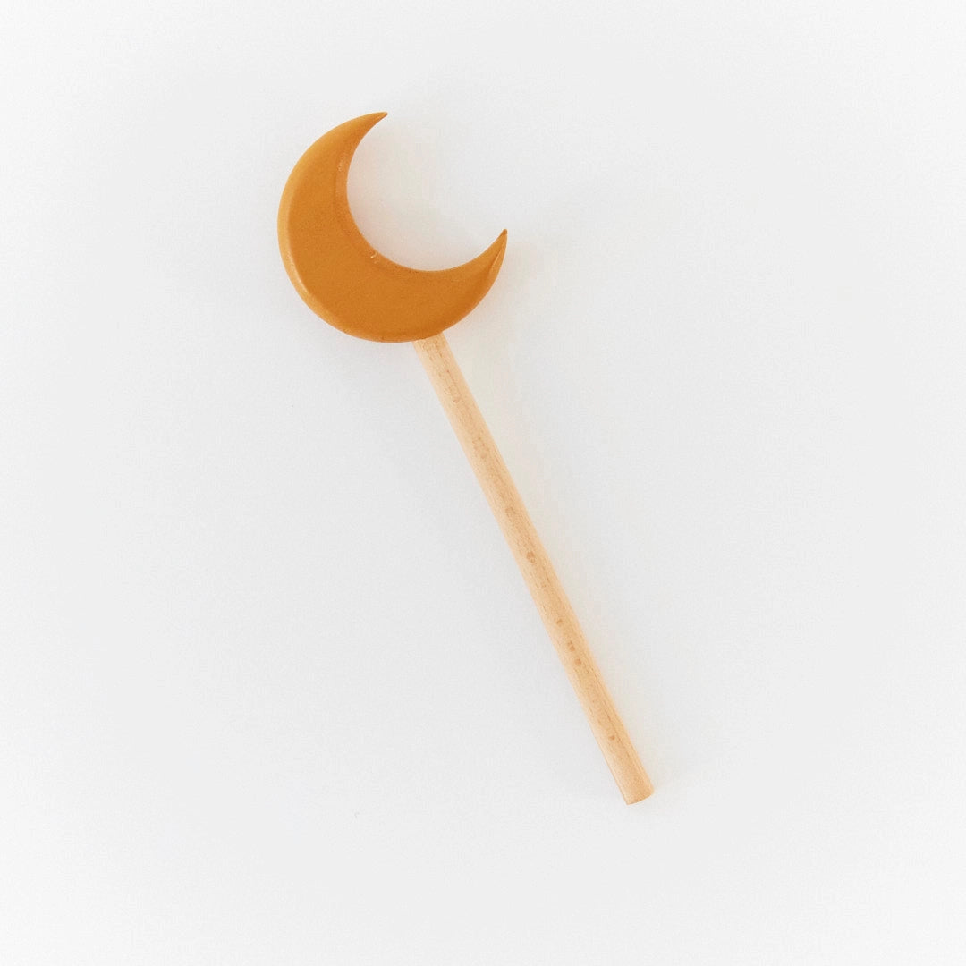 Crescent moon-shaped wand for kids on white background