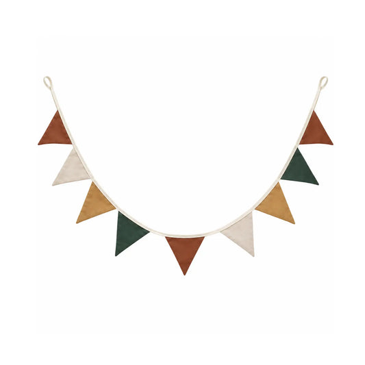 Woodland linen pennant garland in cinnamon, ivory, ochre and deep green hanging against a white brick wall.