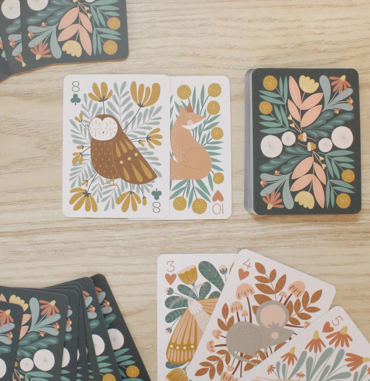 Woodland themed playing cards at table
