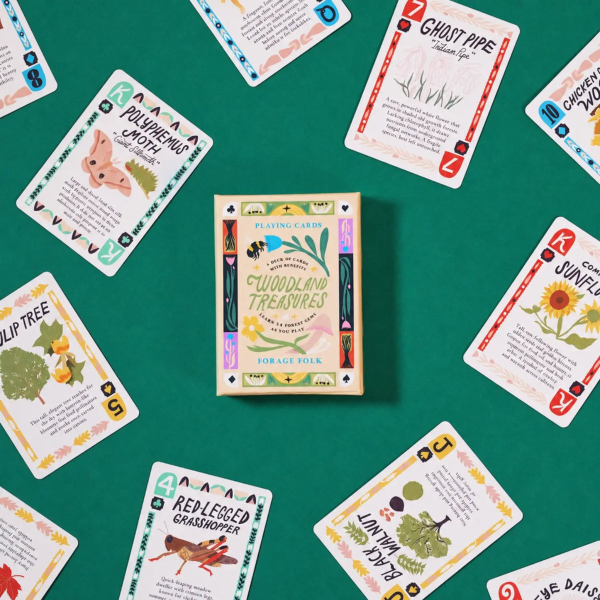 A deck of woodland-themed playing cards called 'Woodland Treasures' with several cards around it