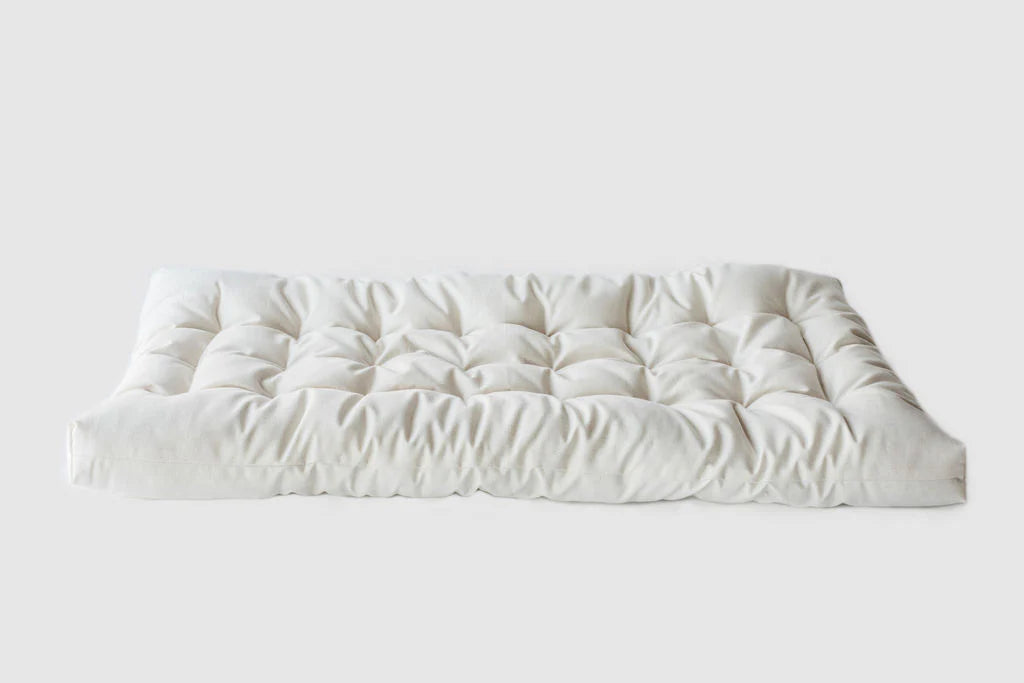 Natural Changing Table Pad made from Organic Cotton and eco Wool on a white background