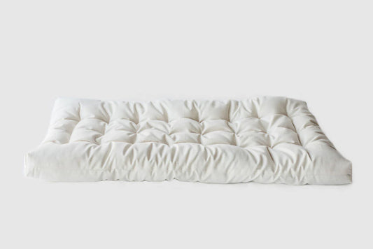 Natural Changing Table Pad made from Organic Cotton and eco Wool on a white background