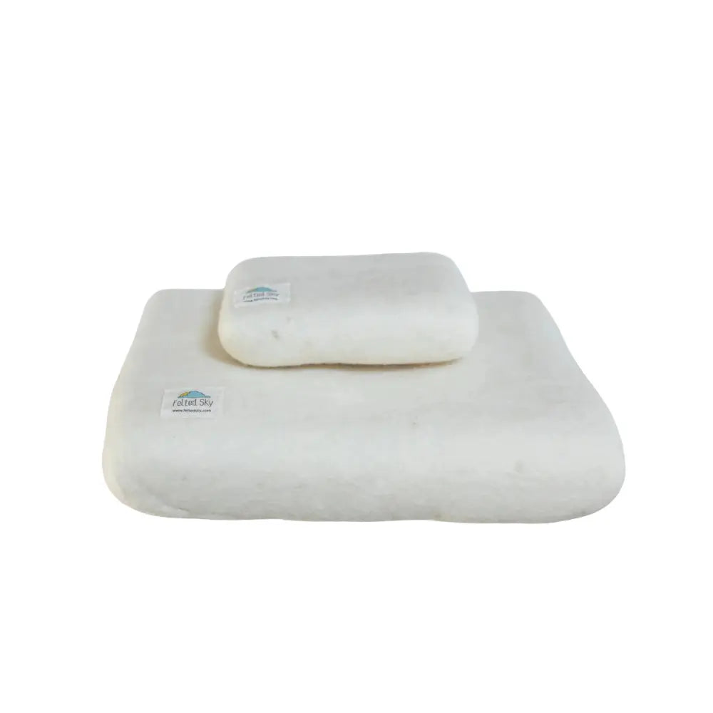 two white felted wool mats for needle felting crafts on a white background