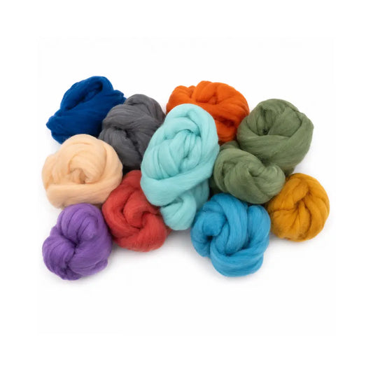 Assorted colorful wool roving knots on a white background