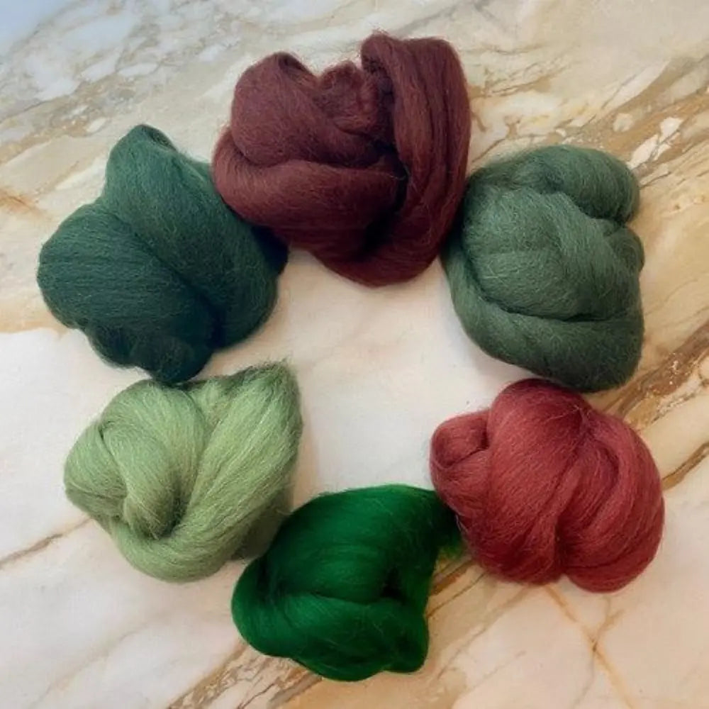 Six Forest Plum wool top color bundle for spinning and felting on marble background