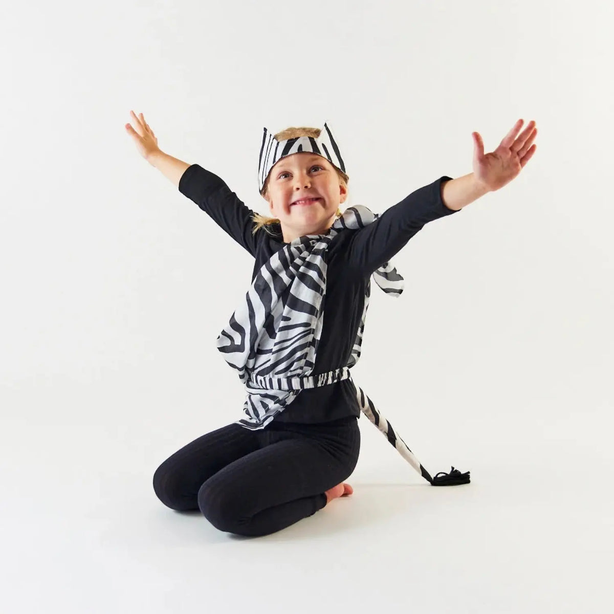 Child using a Zebra Playsilk for zebra-inspired dress-up and imaginative animal play