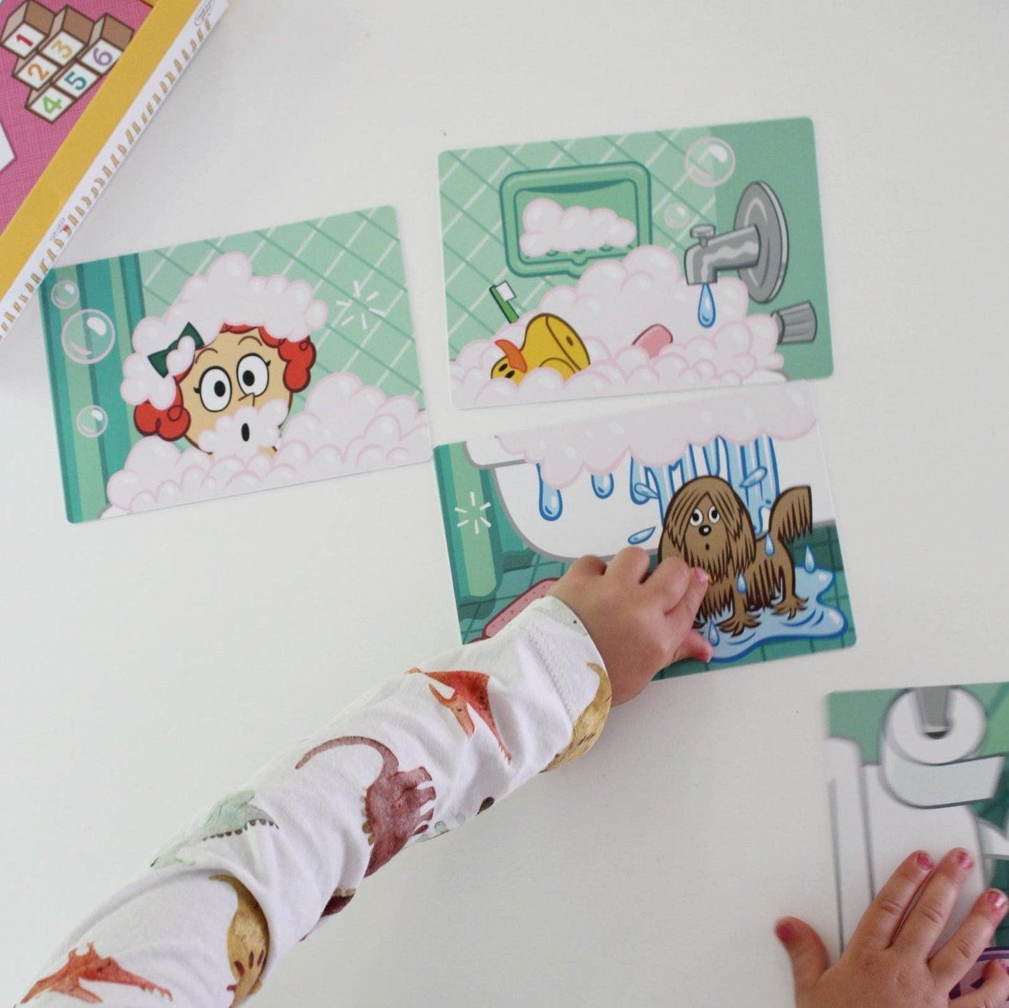 preschool hands playing cards on white background