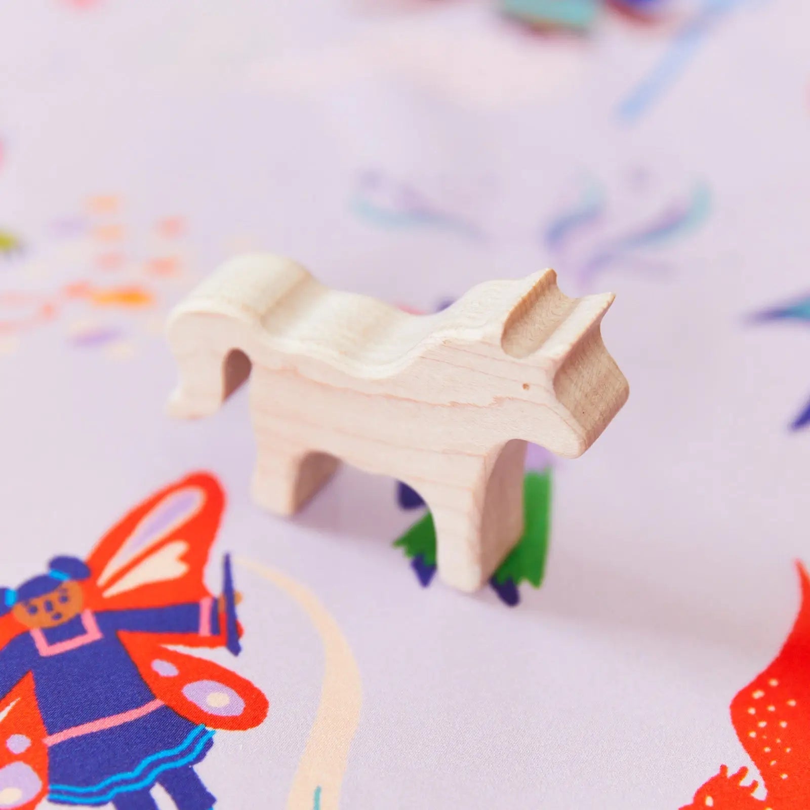 Magical Creatures Seek and Find Playsilk with a wooden unicorn toy on top