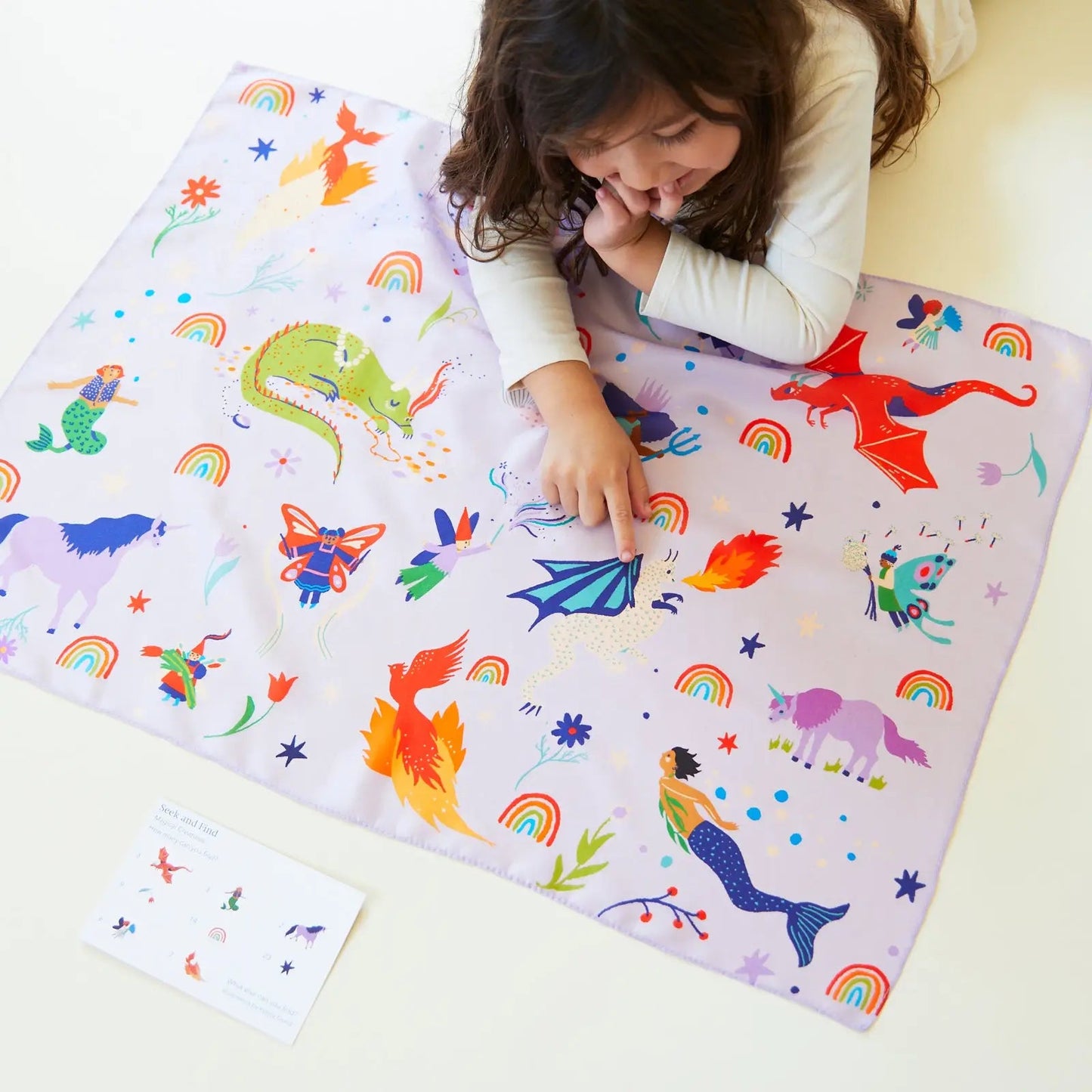 Girl playing with Magical Creatures Seek and Find Playsilk