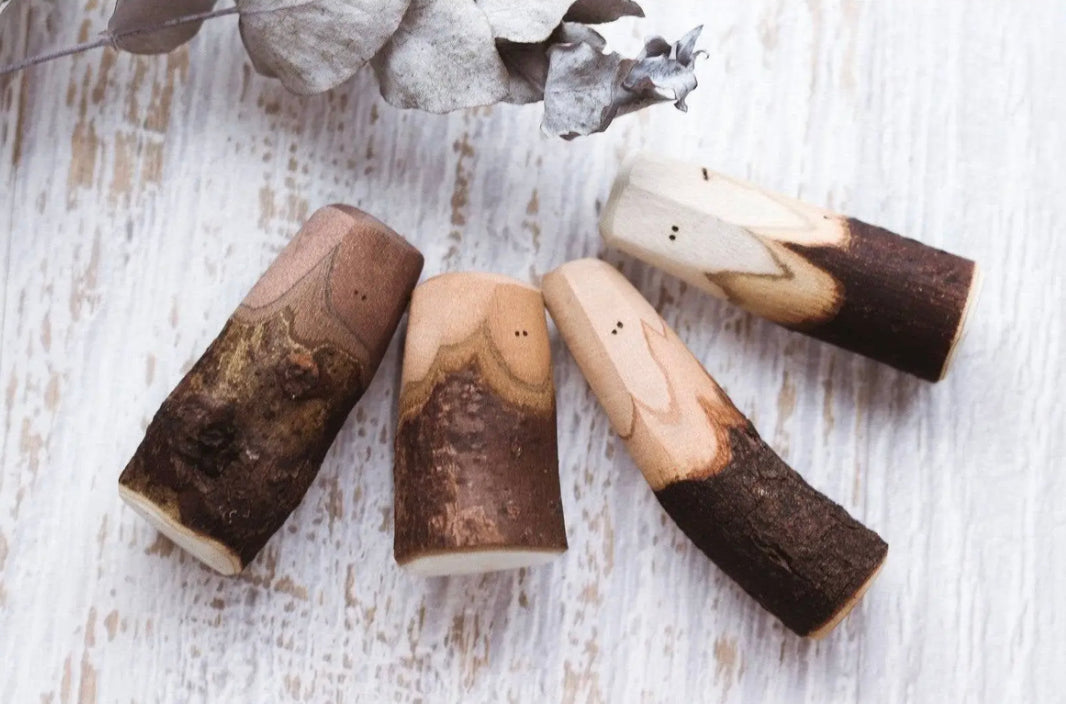 Hand-carved mixed bark Tree People wooden figures showing natural bark and wood grain variations