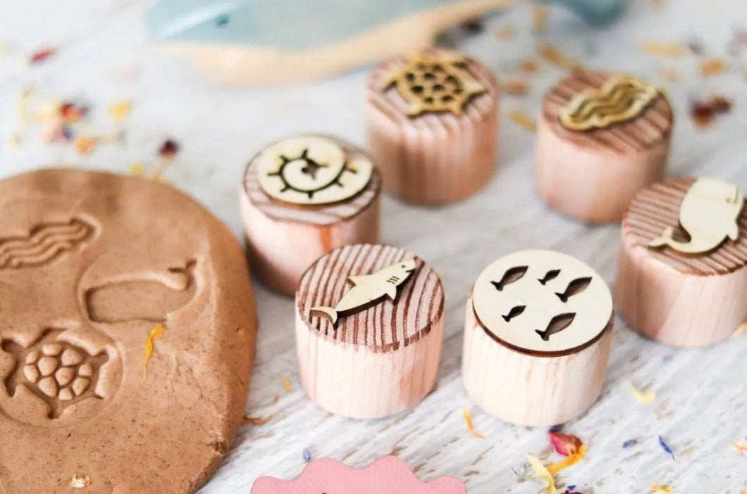 Ocean wooden dough stamps making sea life impressions in natural play dough