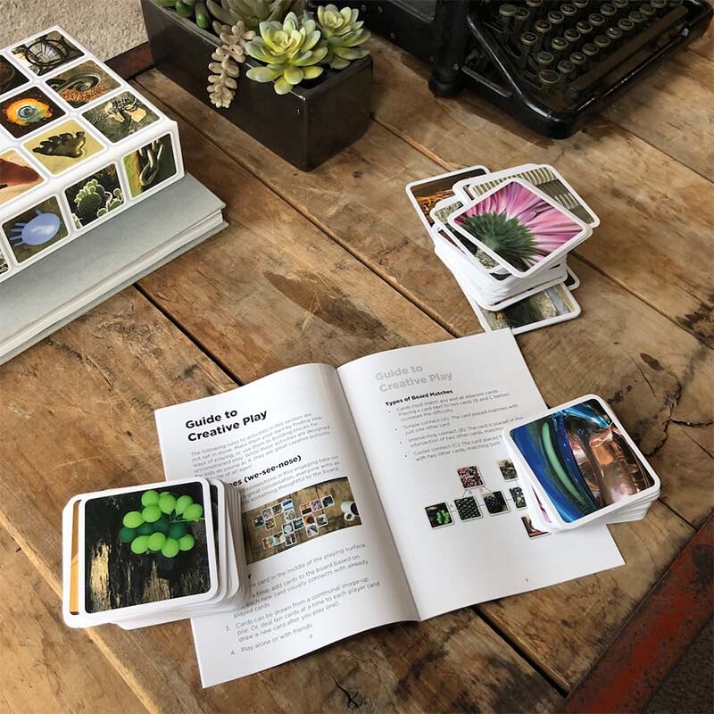 OuiSi visual connection game cards and instructions on wooden desktop