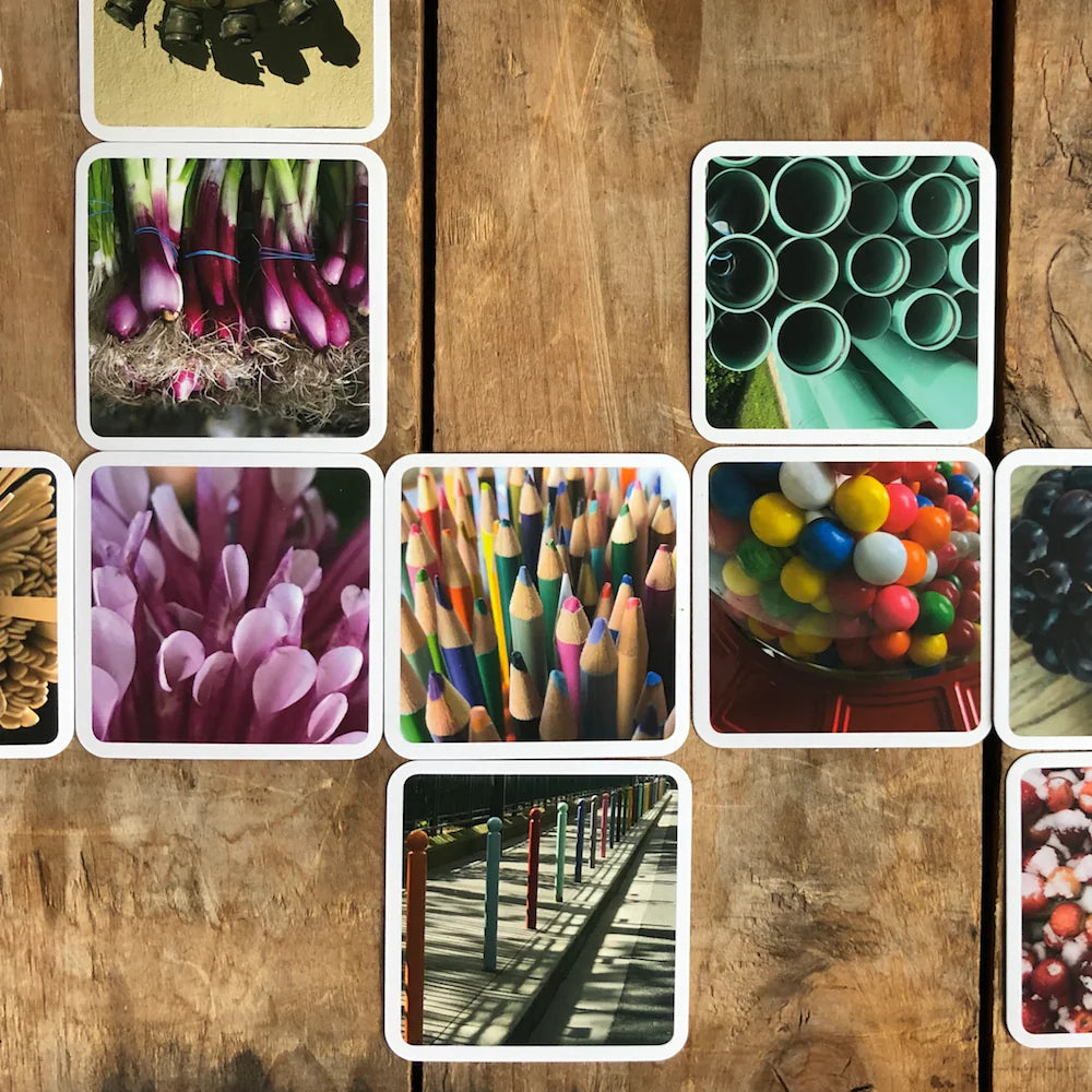 OuiSi photo cards arranged in visual pattern on wooden surface