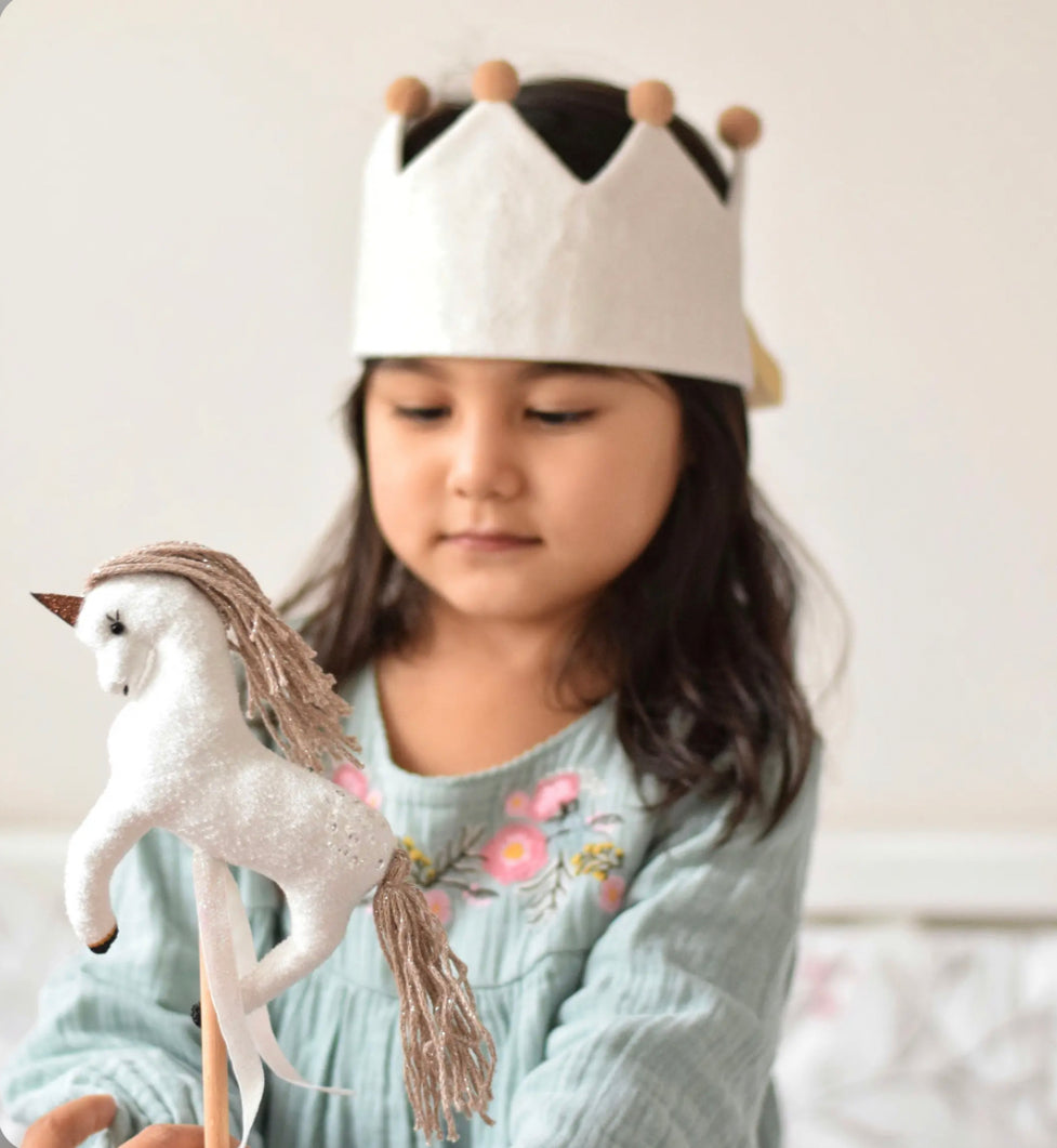 Little Girl Wearing Play Crown and playing with a Magical Unicorn Wand Set