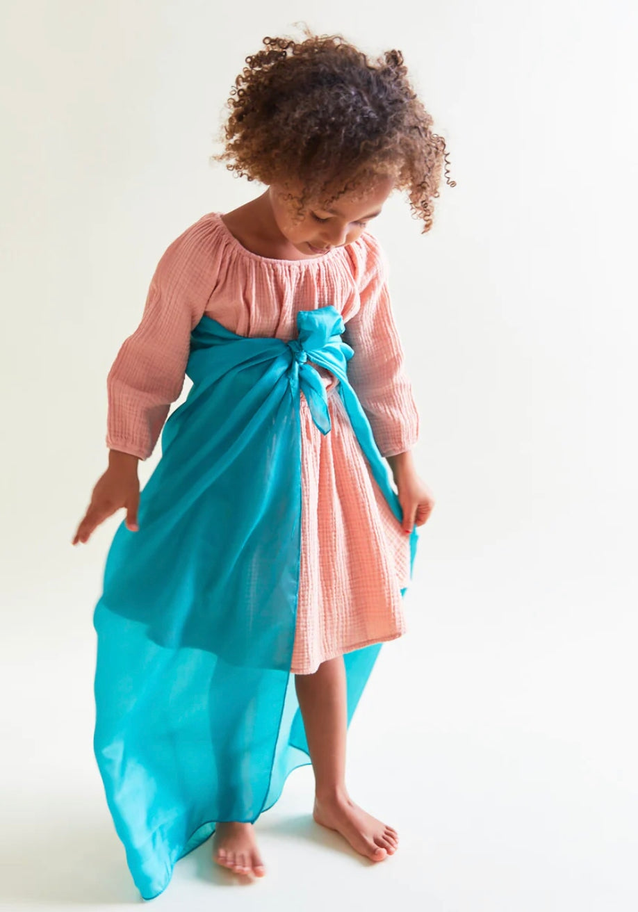 Girl with turquoise playsilk tied around her waist