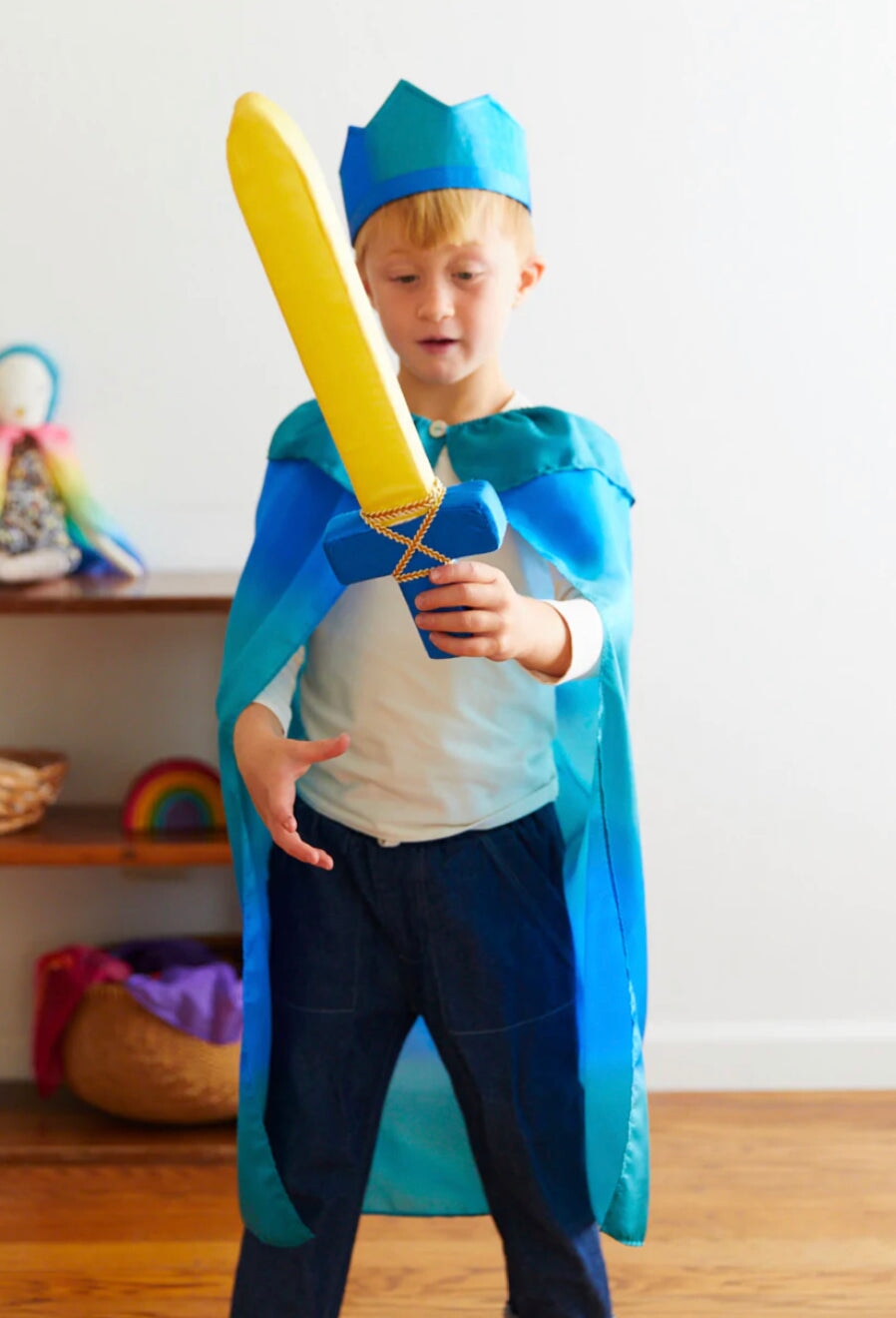 Child in a cape and crown playing with a Soft Sword - Silk + Foam