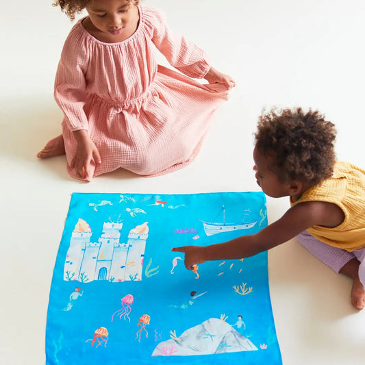 Two Children playing with the Under the Sea Playsilk