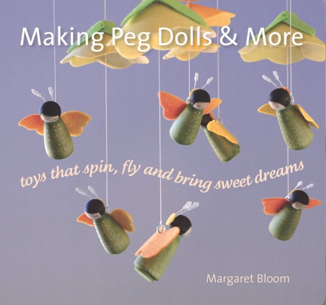 Cover of the book 'Making Peg Dolls & More' showing colorful illustrated peg dolls in various designs against a blue background