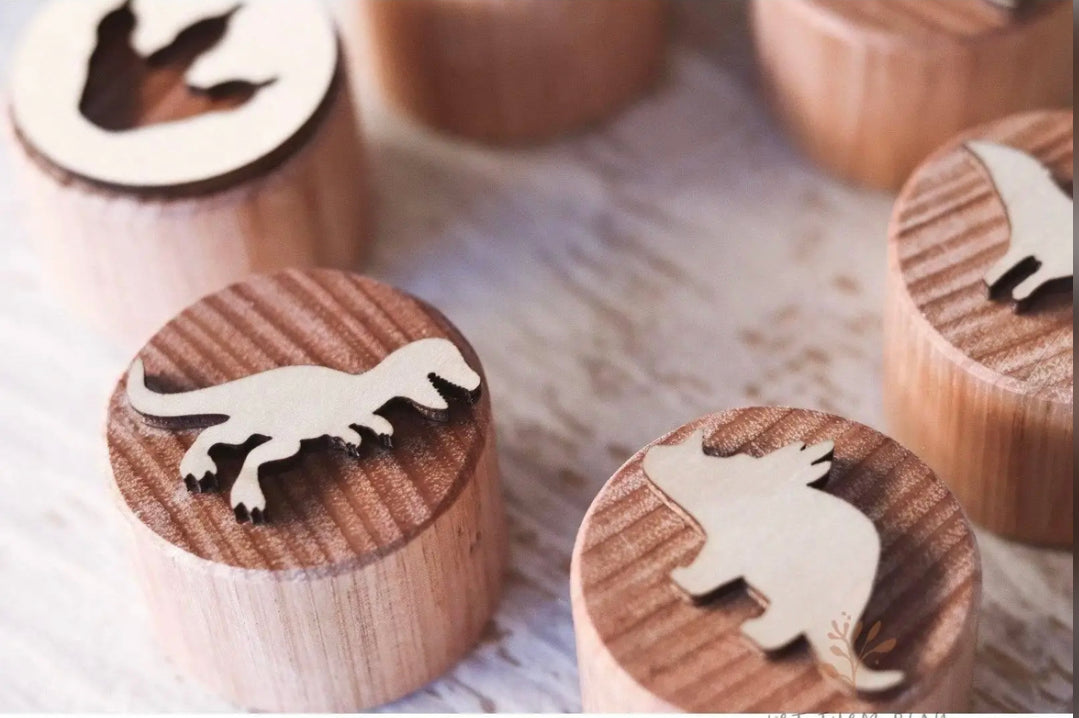Close-up of dinosaur wooden stamps for pressing shapes into play dough, sand, or clay